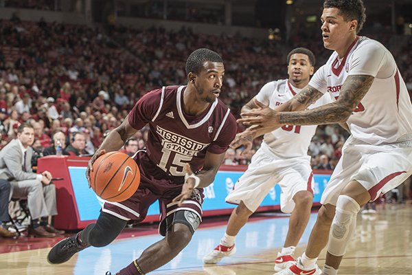 Arkansas forward Dustin Thomas (13) defends Mississippi State guard I.J. Ready (15) in the first half Tuesday, Jan. 10, 2017 at Bud Walton Arena in Fayetteville.