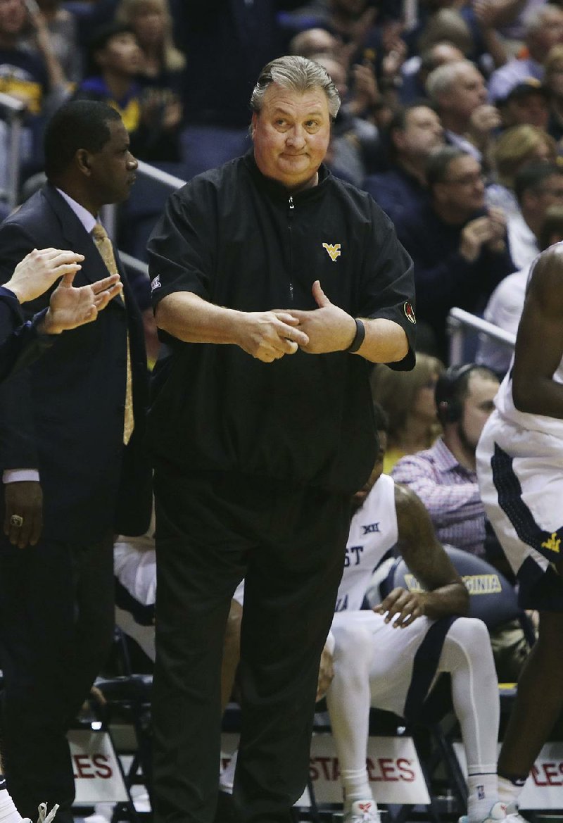 West Virginia Coach Bob Huggins and the No. 10 Mountaineers beat No. 1 Baylor 89-68 on Tuesday night as Nathan Adrian scored a career-high 22 points.