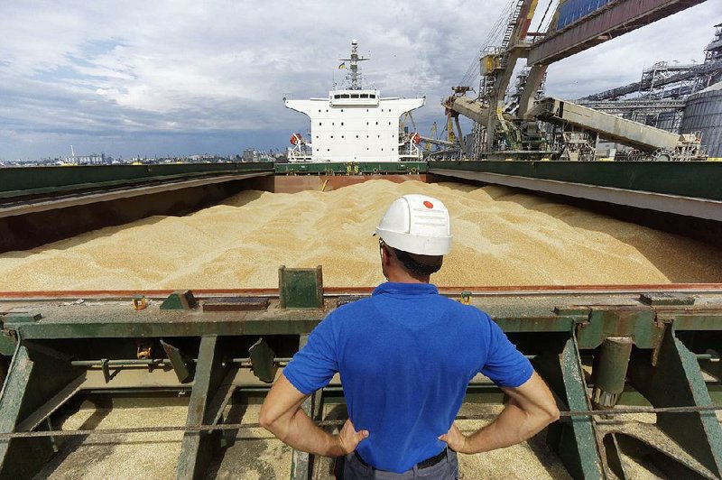 Wheat grain fills the hold of a cargo ship at the port in Nikolaev, Ukraine, in August. Analysts say there are signs a global wheat glut won’t last much longer and that prices for wheat have bottomed out. 