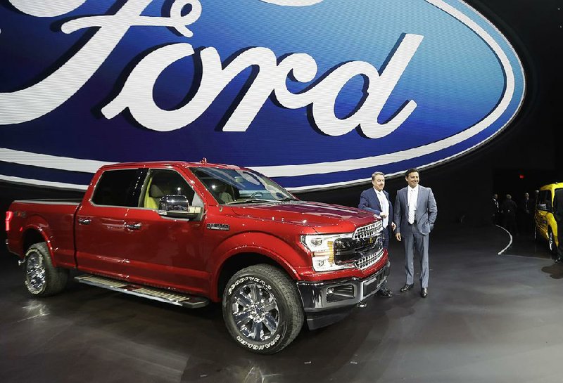 Ford Motor Co. Executive Chairman Bill Ford (left) and Chief Executive Officer Mark Fields stand next to a Ford F-150 pickup Monday at the North American International Auto Show in Detroit.