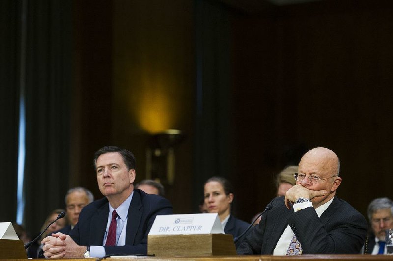 FBI Director James Comey (left) and National Intelligence Director James Clapper testify before the Senate Intelligence Committee about a report on possible Russian tampering with the U.S. elections.