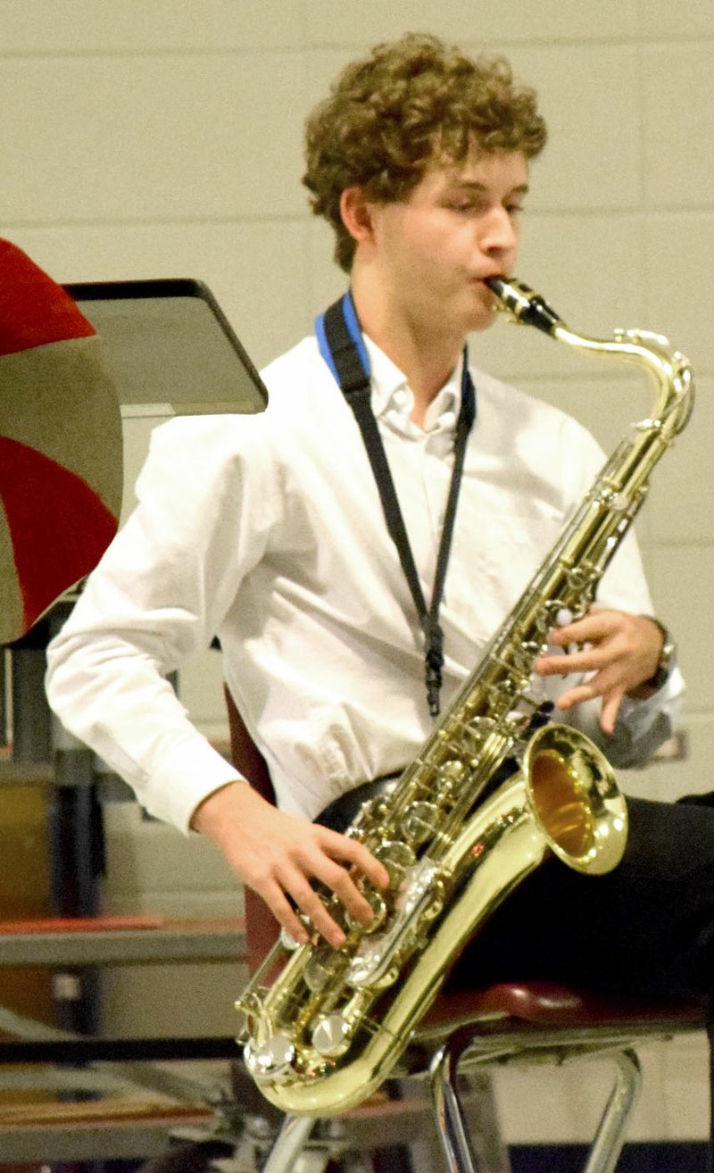 Photo by Mike Eckels Ryan Shaffer, a senior at Decatur, played baritone saxophone during the Dec. 7 Decatur High School winter concert in the cafeteria at the high school. When not in concert, Shaffer serves as drum major for the high school marching band.