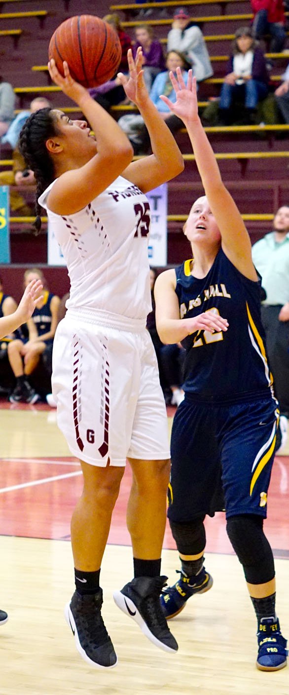 Photo by Randy Moll Chastery Fuamatu, Gentry junior, shoots over a Haas Hall defender during the Jan. 3 game between Gentry and Haas Hall Academy played at Gentry High School.