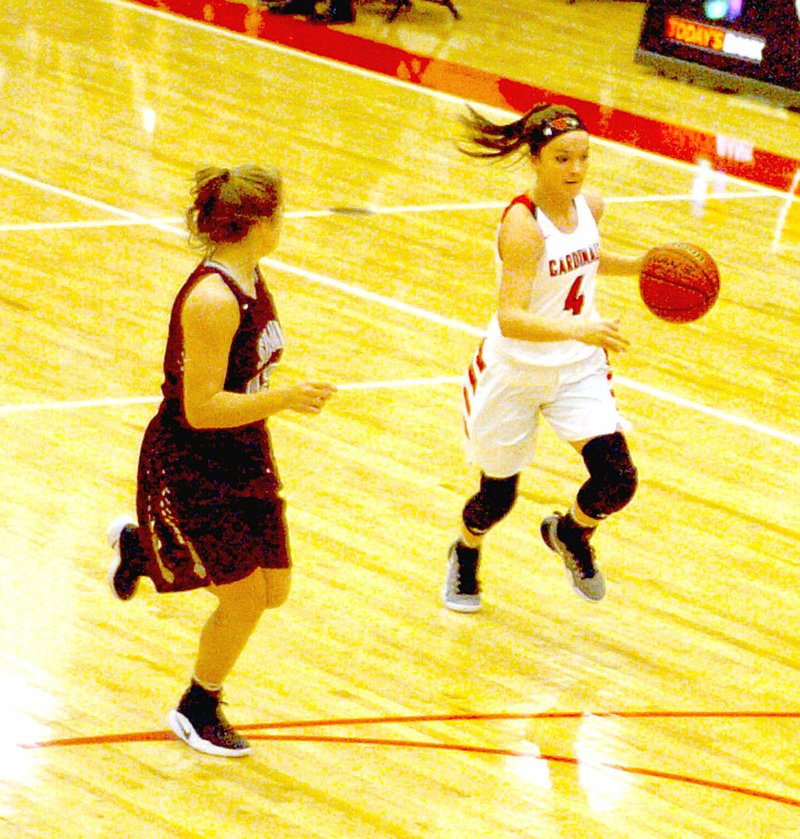 Photo by Mark Humphrey/Enterprise-Leader Farmington sophomore Madisyn Pense attacks Siloam Springs&#8217; transition defense by pushing the ball up-court with her left hand away from a defender trying to stick with her. Pense led the Lady Cardinals with 14 points in a Jan. 3, 40-31, win over the Lady Panthers at Cardinal Arena.