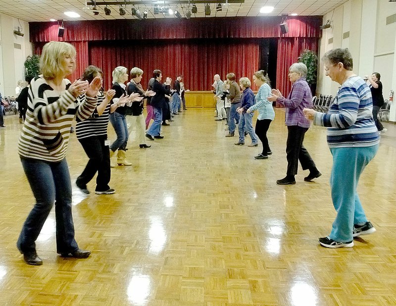 Lynn Atkins/The Weekly Vista Pat Reames, left, and Karen Wenzel, right, are at the end of two of the four lines of line dancers practicing at Riordan Hall last Wednesday. There are about 45 students signed up, instructor Kristine Schnap said, but usually no more than 35 dance. The group meets at Riordan Hall beginning at 12:45 p.m. every Monday, Wednesday and Friday.