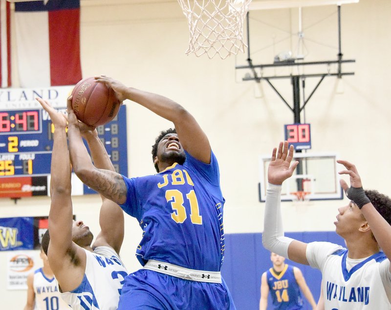 Photo courtesy of Wayland Baptist Sports Information John Brown freshman Brenton Toussaint tries to power his way to the basket Saturday at Wayland Baptist (Texas). The Pioneers defeated the Golden Eagles 91-66. JBU returns to Texas on Thursday to play at Southwestern Assemblies of God.