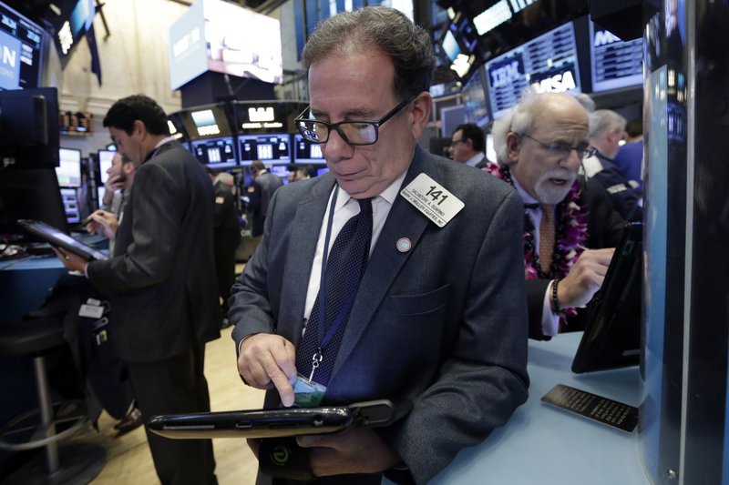 Sal Suarino, center, works with fellow traders on the floor of the New York Stock Exchange, Tuesday, Jan. 10, 2017. The stock market is getting off to a mixed start as drops in real estate and utilities offset gains in other sectors including health care. 