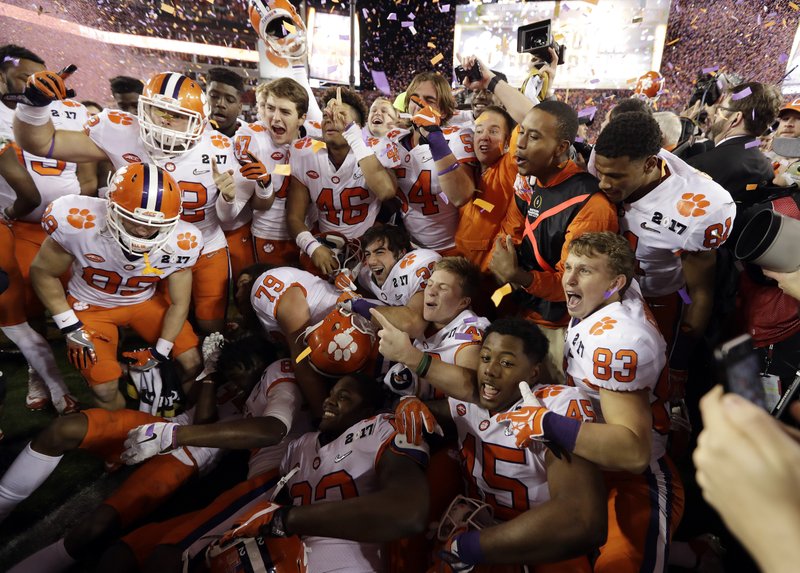 The Associated Press NATIONAL CHAMPIONS: Clemson players celebrate after a 35-31 win over Alabama in the NCAA college football playoff championship game Monday night in Tampa, Fla.