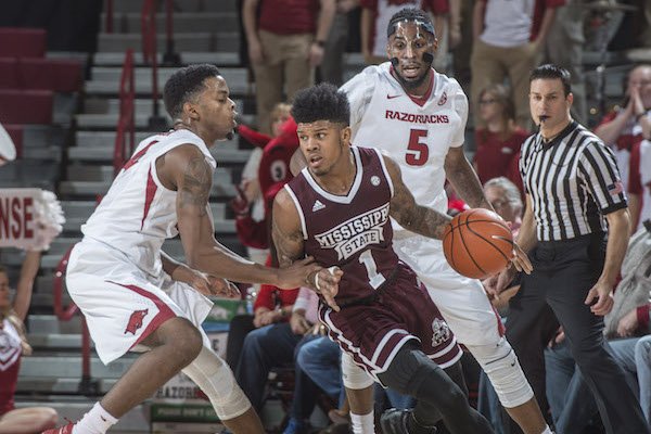 Mississippi State's Lamar Peters surveys the floor while being guarded by Arkansas' Daryl Macon in the Bulldogs' 84-78 win in Bud Walton Arena on Tuesday, Jan. 10, 2017.