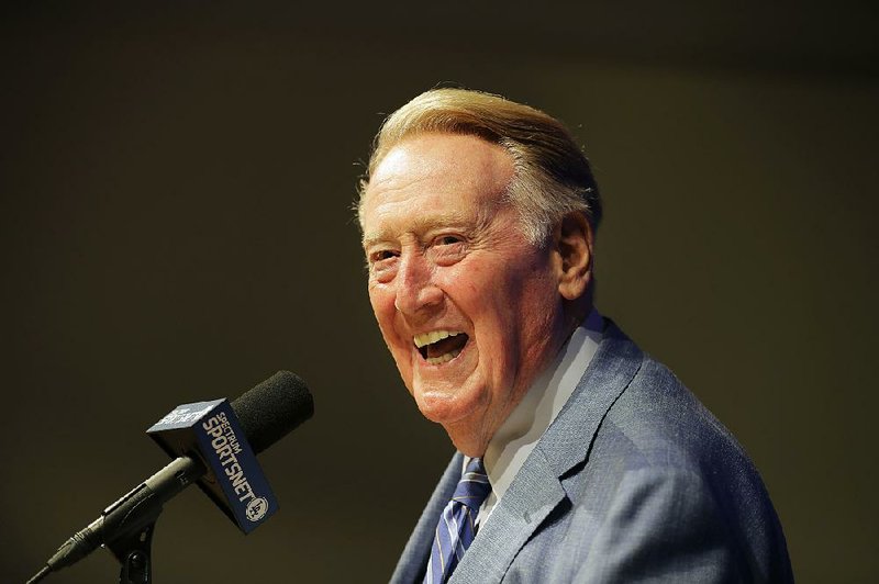  In this Sept. 24, 2016, file photo, Los Angeles Dodgers and Hall of Fame broadcaster Vin Scully smiles as he answers questions during a news conference at Dodger Stadium in Los Angeles.