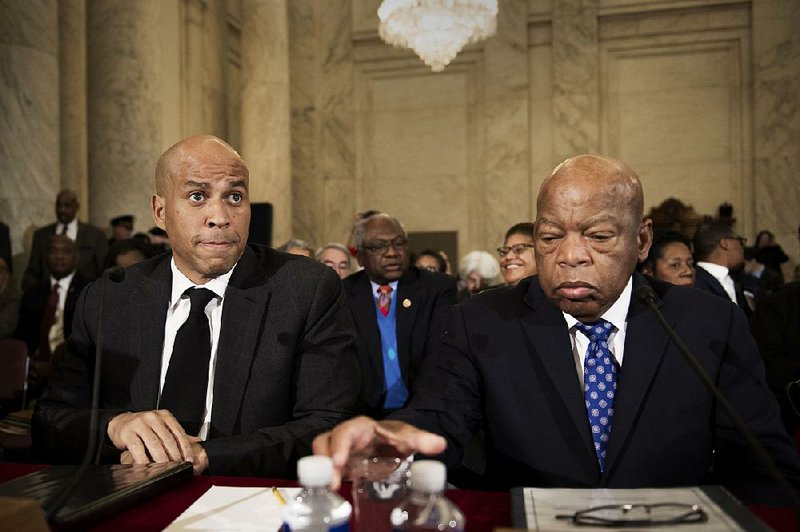Democratic Sen. Cory Booker (left) of New Jersey and Rep. John Lewis of Georgia testify Wednesday at the confirmation hearing for attorney general nominee Jeff Sessions. Both oppose Sessions.
