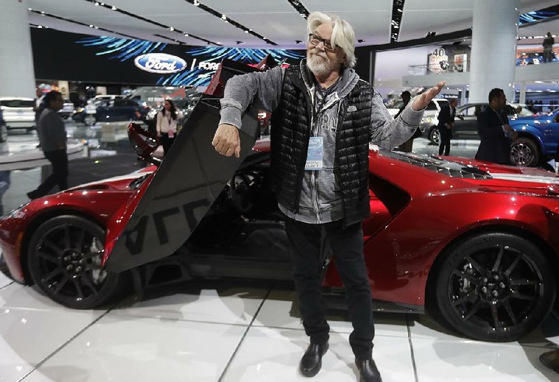 Singer Bob Seger shows his approval of a new Ford GT after sitting in it Tuesday at the North American International Auto Show in Detroit. 