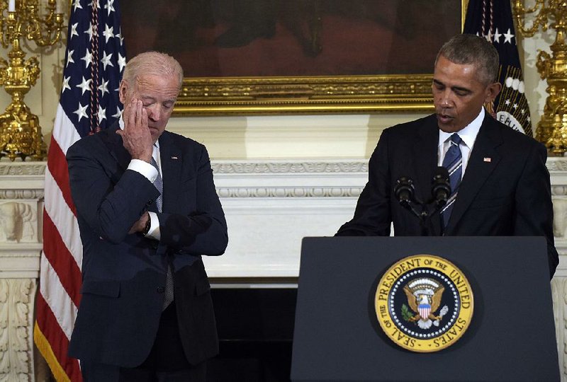 Vice President Joe Biden listens to President Barack Obama speak about their time together Thursday at the White House. “To know Joe Biden is to know love without pretense, service without self-regard, and to live life fully,” Obama said as Biden wiped tears.
