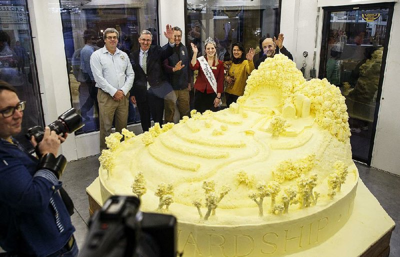 Dairy industry officials are among people posing last week with a butter sculpture at the Pennsylvania Farm Show in Harrisburg. U.S. demand for cheese and butter is on the rise.