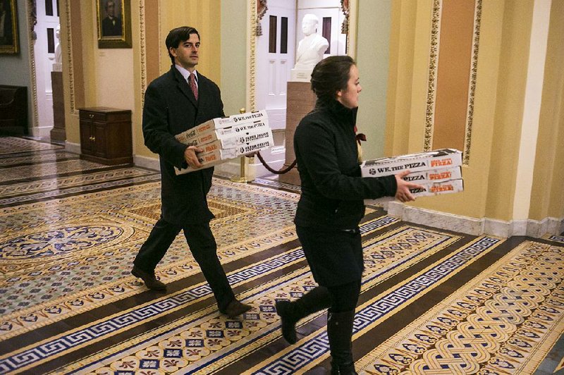 Pizzas ordered by Senate Democrats arrive at the U.S. Capitol on Wednesday evening during a series of after-hours votes that stretched into Thursday morning.