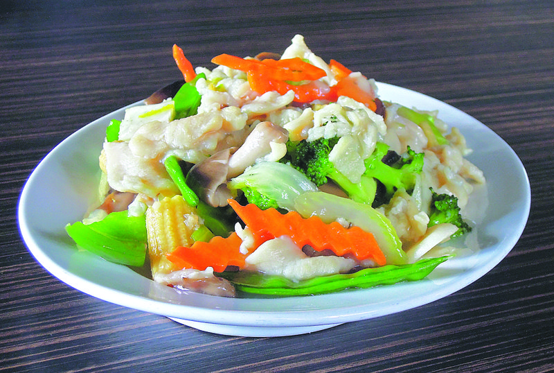 The chicken with mixed vegetables is sliced chicken stir-fried with a Chinese vegetable medley in a light Asian sauce.