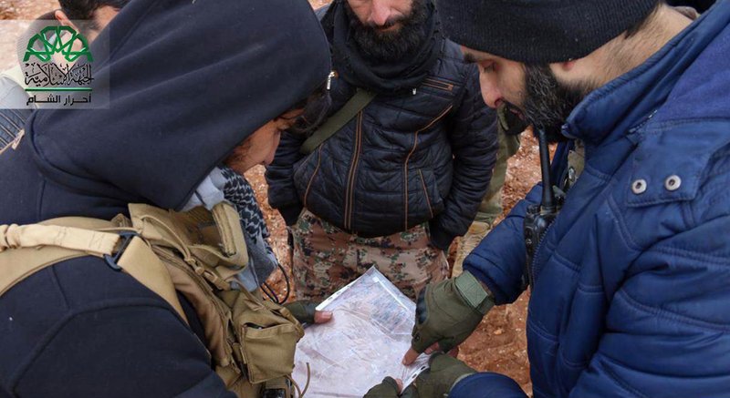 This picture posted on Dec. 11, 2016, by the Syrian militant group Ahrar al-Sham, purports to show Ahrar al-Sham fighters consulting a map in the countryside around the northern Syrian town of al-Bab, Aleppo province, Syria. 
