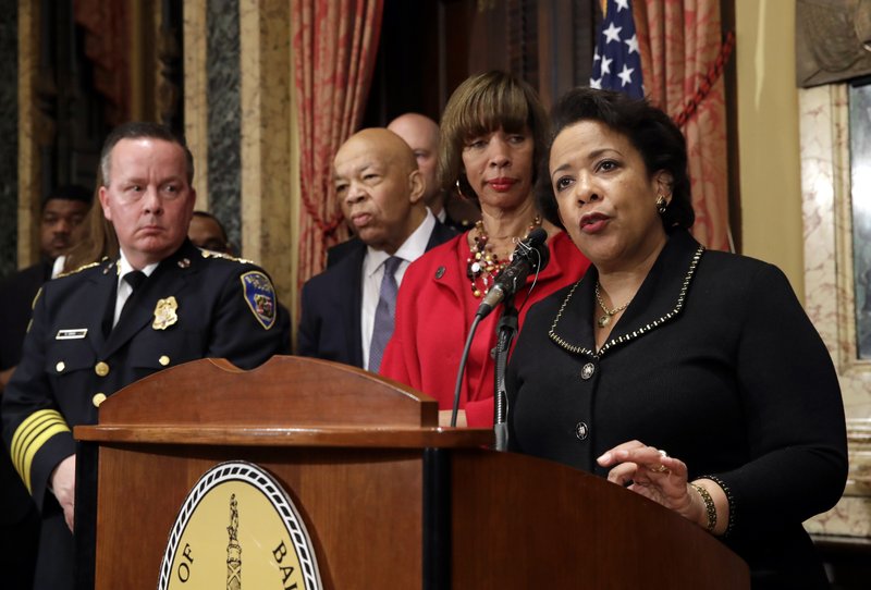 Attorney General Loretta Lynch, right, speaks during a joint news conference in Baltimore, Thursday, Jan. 12, 2017, to announce the Baltimore Police Department's commitment to a sweeping overhaul of its practices under a court-enforceable agreement with the federal government. Standing behind Lynch are Baltimore Police Department Commissioner Kevin Davis, from left, Rep. Elijah Cummings, D-Md., and Baltimore Mayor Catherine Pugh. 