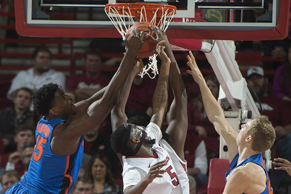 Arkansas and Florida players battle for a rebound during a game Thursday, Dec. 29, 2016, in Fayetteville. 