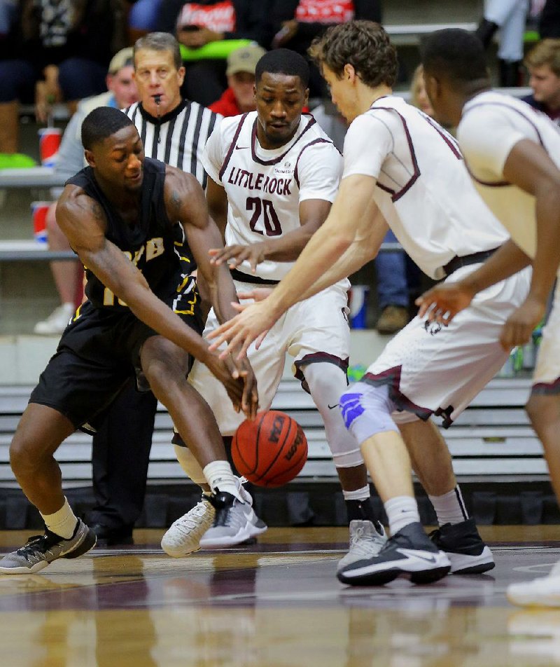 UALR forward Ben Marcus (center) and Lis Shoshi (right) trap UAPB guard Trent Steen during their game on Dec. 8. The Trojans’ 67-52 victory pushed their record to 7-2 at the time, but UALR has gone 4-4 since, including 2-2 in Sun Belt Conference play.