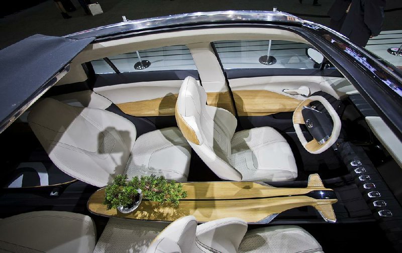 A potted bonsai tree is fitted into the center console in a GAC EnSpirit concept vehicle at the North American International Auto Show this week in Detroit
