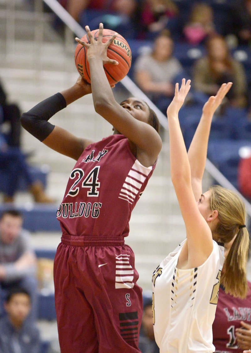 Marquesha Davis (24) of Springdale High shoots as Brittany Crowson of Bentonville West defends on Friday at Wolverine Arena in Centerton.