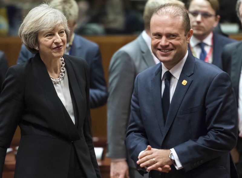 This is a Thursday, Dec. 15, 2016 file photo of British Prime Minister Theresa May, left, speaks with Malta's Prime Minister Joseph Muscat, during a round table meeting at an EU Summit in Brussels. 