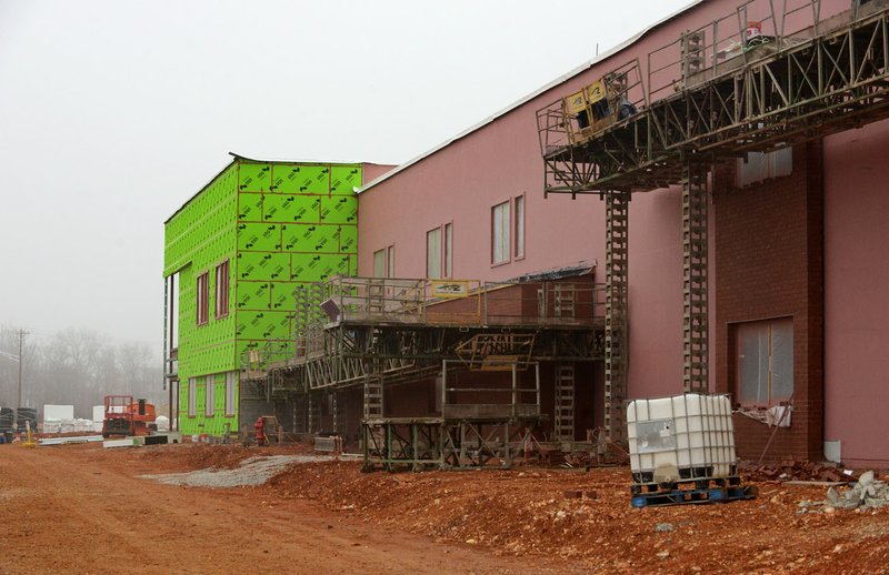 Construction progresses Friday on the elementary school entrance area at the Osage Creek Elementary and Creekside Middle schools in Bentonville. The schools will be connected and share some spaces, including the cafeteria and library.