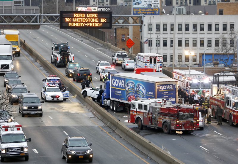 FILE - In this Dec. 27, 2016 file photo, emergency personnel work at the scene of a fatal multi-vehicle crash on the eastbound side of the Bronx Expressway in the Bronx section of New York. The government says traffic fatalities surged about 8 percent in the first nine months of last year, continuing an alarming upward spiral that began in late 2014. The National Highway Traffic Safety Administration said the sharp increase comes at the same time Americans are putting more miles on the road than ever before. But the rise in deaths is outpacing the increase in travel. Vehicle miles traveled in the first nine months of 2016 increased about 3 percent. (AP Photo/Seth Wenig, File)