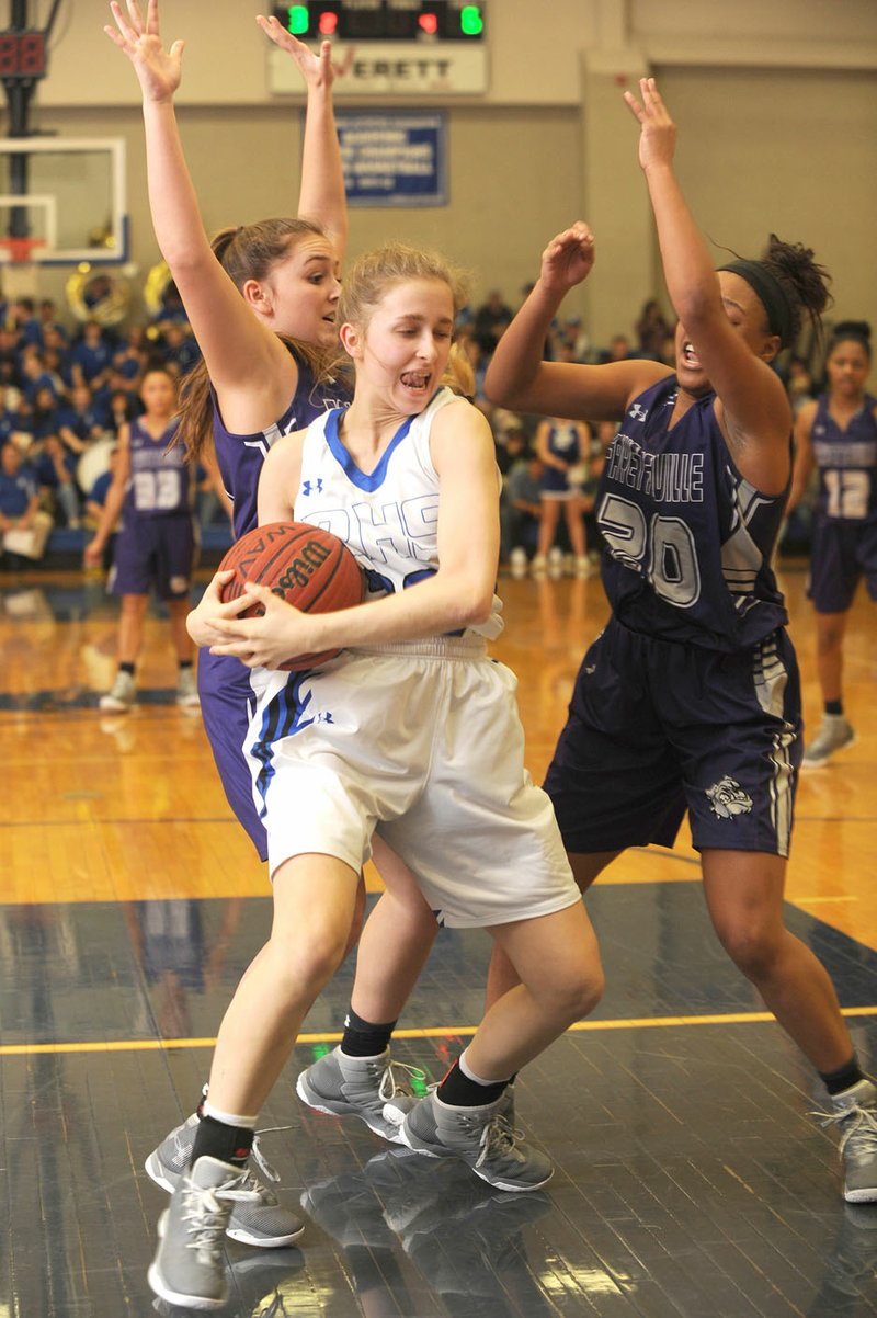 NWA Democrat-Gazette/ANDY SHUPE Madison Sherrill (center) of Rogers High protects the ball while Destiny Posey (20) of Fayetteville and a teammate apply pressure Friday at King Arena in Rogers. Visit nwadg.com/photos for more pictures from the game.