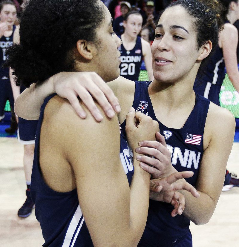 Connecticut guard Kia Nurse (right) hugs teammate Gabby Williams after the Huskies earned their 91st consecutive victory Saturday, 88-48 over SMU in Dallas. 