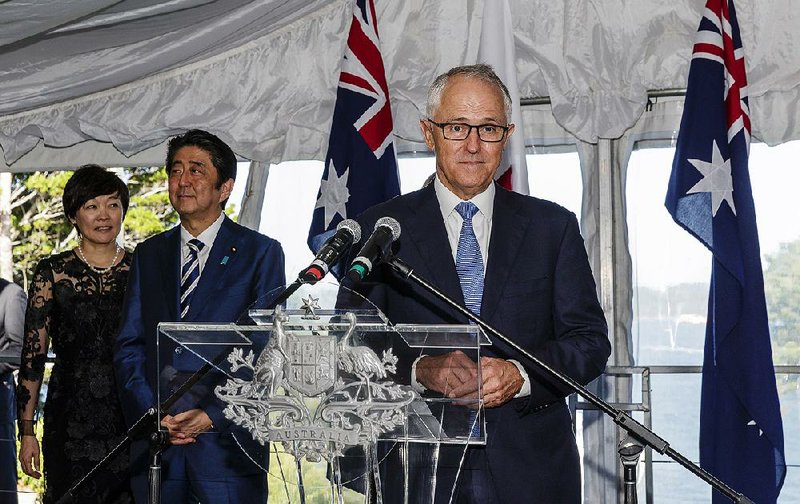 Australian Prime Minister Malcolm Turnbull delivers a speech Saturday as Japanese counterpart Shinzo Abe (second left) looks on during a reception at Kirribilli House in Sydney.