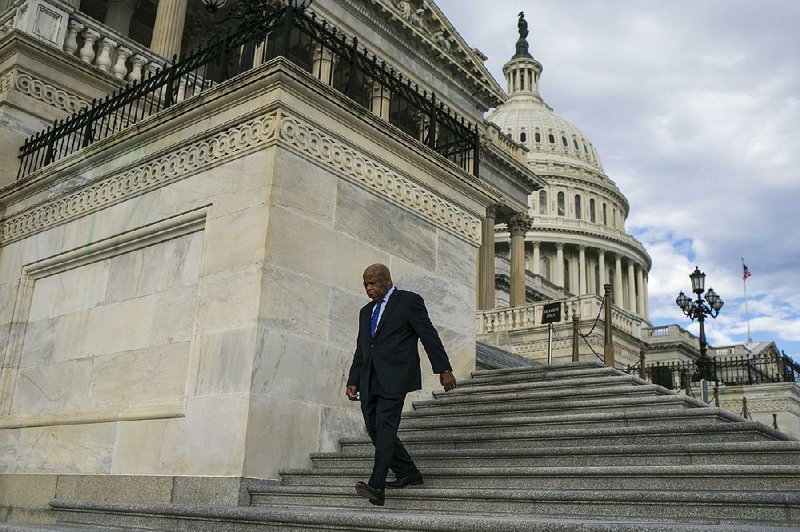 Rep. John Lewis leaves the U.S. Capitol on Friday after an intelligence briefi ng for House members. President-elect Donald Trump on Saturday criticized the longtime civil-rights leader as being “all talk” after Lewis said he won’t attend Trump’s inauguration and doesn’t consider him a legitimate president.