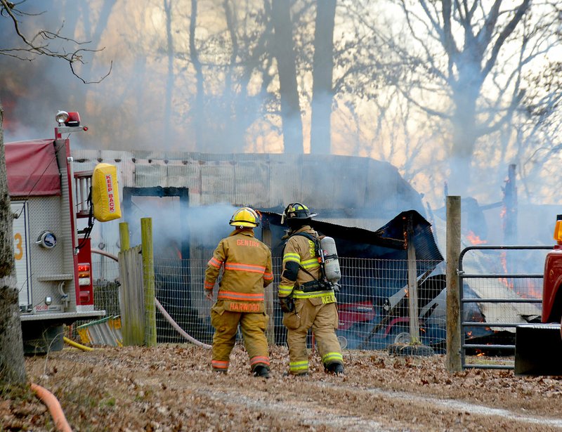 Janelle Jessen/Siloam Sunday A brush fire on Tuesday afternoon burned a shop building and threatened several homes at the intersection of Fisher Ford Road and Nicodemus Church Road.