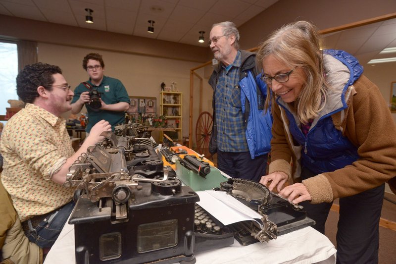 Carol Daggett and Jon Dalrymple of Fayetteville take a look Saturday at the vintage typewriters in Danny Baskin’s (left) collection during the open house at the Shiloh Museum of Ozark History in Springdale. Allyn Lord, director, said the museum has benefited from General Improvement Fund grants.