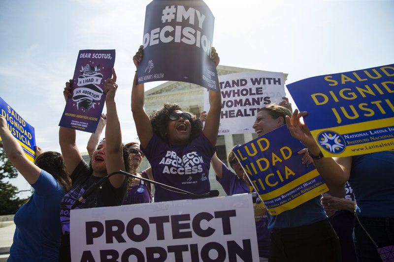 FILE - June 27, 2016 file photo pro-abortion rights activists celebrate during a rally at the Supreme Court in Washington. The tens of thousands of women flocking to Washington for a march on the day after Donald Trump's inauguration come packing a multitude of agendas, but are united in their loathing for Trump. 