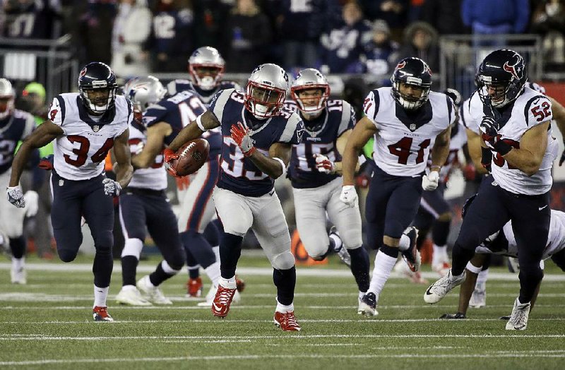 New England running back Dion Lewis runs past several Houston defenders for a 98-yard kickoff return for a touchdown during the Patriots’ 34-16 victory in an AFC division round playoff game Saturday night. Lewis also had a 13-yard touchdown catch and a 1-yard touchdown run.