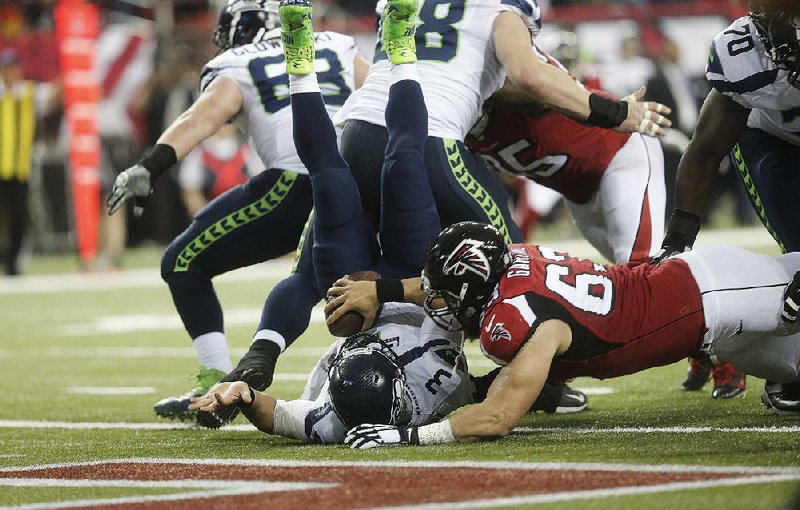 Seattle quarterback Russell Wilson is tackled in the end zone for a safety in the first half of Saturday’s NFC divisional playoff game at Atlanta. The Falcons went on to win the game and to put an end to the Seahawks’ season.