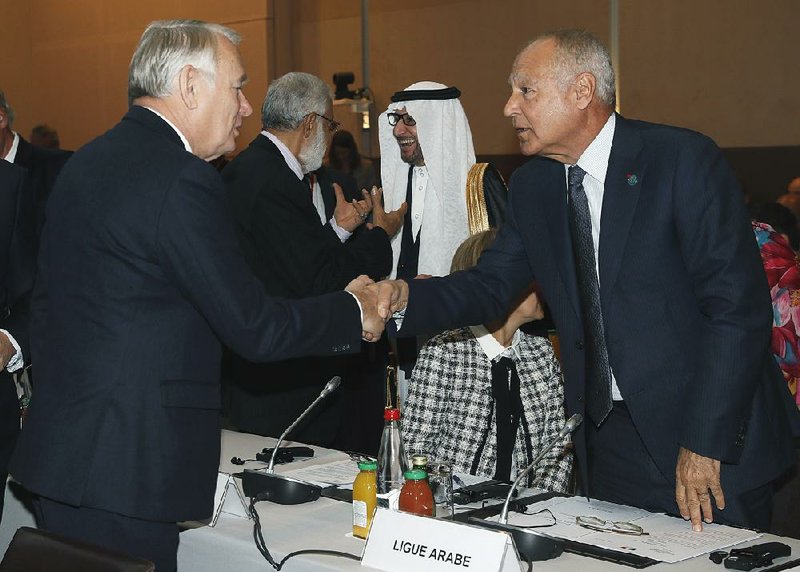 French Minister of Foreign Affairs Jean-Marc Ayrault (left) greets Arab League Secretary-General Ahmed Aboul-Gheit at the opening of the Mideast peace conference in Paris on Sunday.
