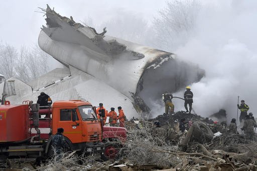 Kyrgyz Emergency Ministry officials and firefighters work among remains of a crashed Turkish Boeing 747 cargo plane at a residential area outside Bishkek, Kyrgyzstan, on Monday, Jan. 16, 2017. 