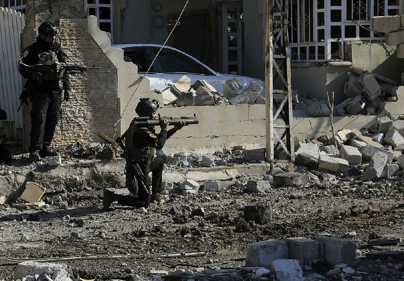 Iraqi special forces take combat positions Monday as they advance in eastern Mosul. A United Nations official said the Islamic State is targeting civilians who try to fl ee the city’s militant-held areas.