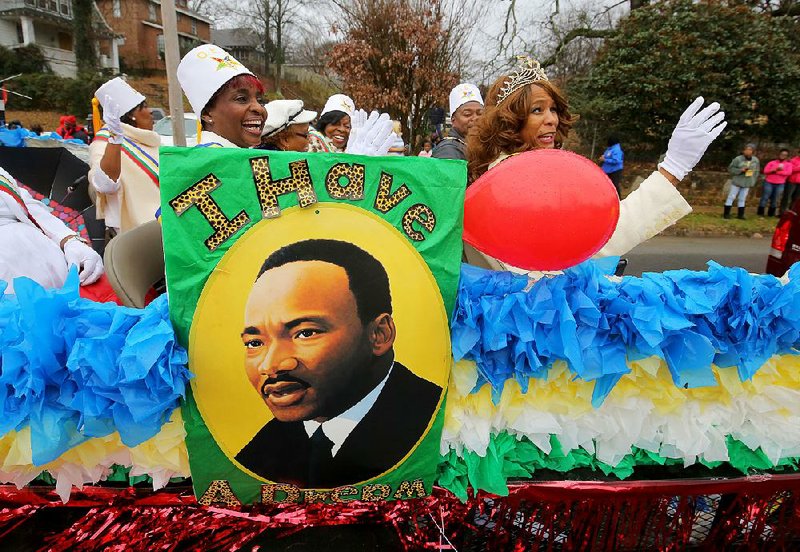 Deborah Washington (left) and Jacquelyn Block, members of St. Paul Grand Lodge’s Daughters of Ruth chapter, wave from their float Monday in Little Rock during a march and parade honoring civil-rights leader Martin Luther King Jr. More photos are available at arkansasonline.com/galleries.