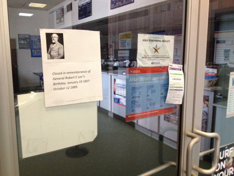 A sign posted Monday on the door of the post office at 429 Holcomb St. in Springdale.