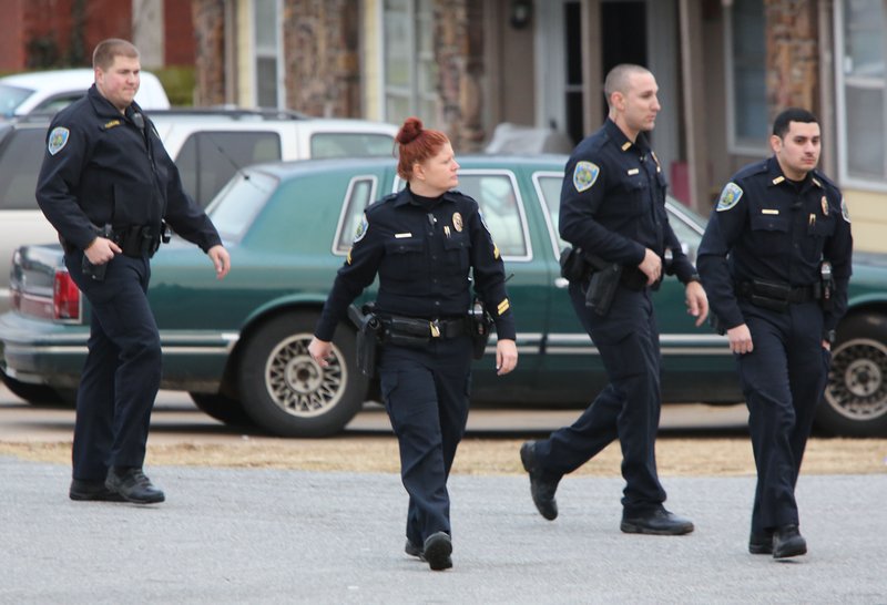 Personnel with the Fayetteville Police Department patrol Tuesday an area near West Deane Street and North Porter Road. The officers were responding to a disturbance involving a suspect allegedly firing shots at a home at 1655 N. Saddlehorn Ave.