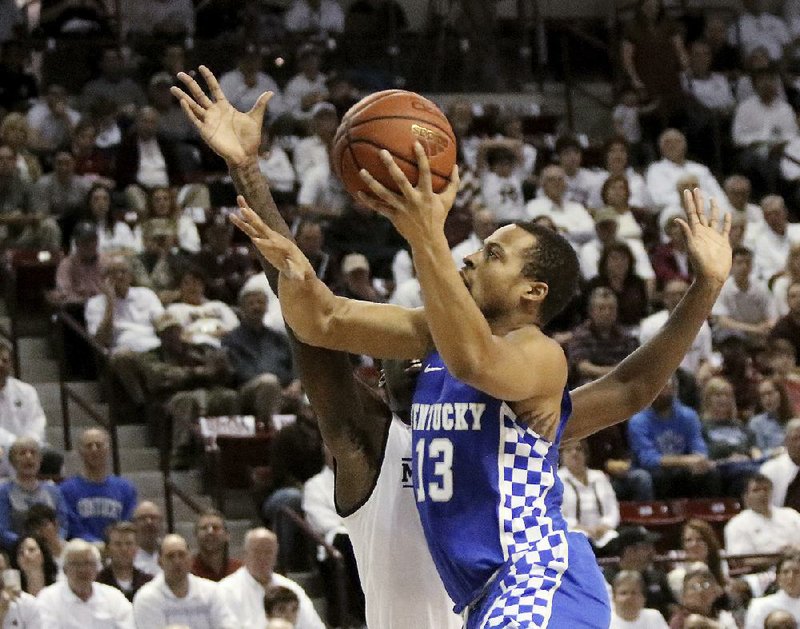 Kentucky guard Isaiah Briscoe (right) heads toward the basket while Mississippi State forward Mario Kegler defends in Tuesday night’s game. The Wildcats led by 18 points in the second half but needed a late flurry to hold off the Bulldogs 88-81.