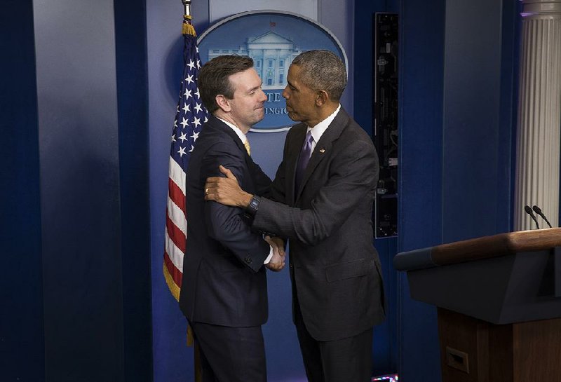 White House press secretary Josh Earnest gets a surprise visit Tuesday from President Barack Obama during Earnest’s final news conference at the White House press briefing room.