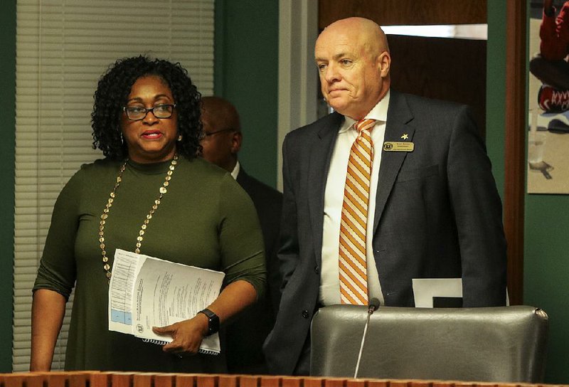 Sadie Mitchell, Little Rock School District associate superintendent, arrives Tuesday with Superintendent Mike Poore for a news conference on proposed budget cuts and other district changes. Poore announced that Mitchell would direct the implementation of the plans. 