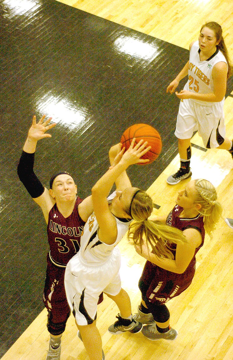 Photo by Mark Humphrey/Enterprise-Leader/Prairie Grove&#8217;s Emily Grant tries to get up a shot on the baseline while Lincoln&#8217;s Kendra Cummings (No. 31) attempts to block the shot with Lady Wolf Lexington Dobbs and Lady Tiger Parker Lopez moving in to help. Prairie Grove defeated Lincoln, 32-30, in a game that went down to the wire Jan. 11.
