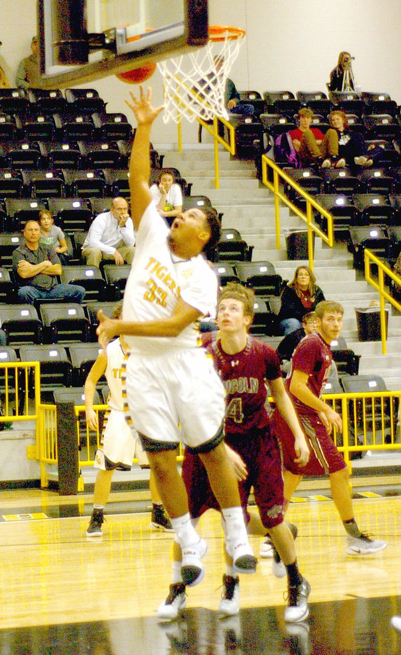 Photo by Mark Humphrey/Enterprise-Leader/Up and in. Prairie Grove junior DeMarkus Cooper powers in a shot off the glass. Cooper had 13 points, several key rebounds and timely assists during Prairie Grove&#8217;s 55-38 victory against the Wolves Jan. 11.