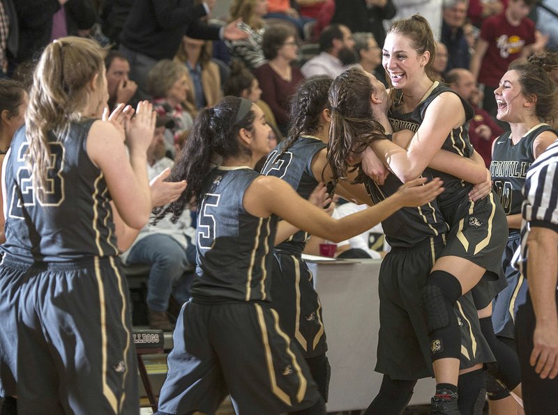Bentonville High players celebrate Tuesday after their come-from-behind victory against Springdale High at Bulldog Gymnasium in Springdale.